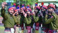 Indian Punjab police personnel take selfies during a full dress rehearsal for the upcoming 70th Republic Day parade in Amritsar on January 24, 2019. India will be celebrating its 70th Republic Day on January 26. AFP / Narinder Nanu
