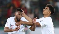 Qatar's Abdelaziz Hatim celebrates scoring their first goal with team mates. Reuters/Suhaib Salem 
