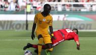 (FILES) In this file photo taken on January 11, 2019 Australia's forward Awer Mabil (L) fights for the ball with Palestine's midfielder Jonathan Zorrilla during the 2019 AFC Asian Cup group B football match between Palestine and Australia at the Maktoum B