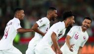 Qatari players celebrate their victory against South Korea.