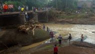 This picture taken on January 25, 2019 shows Indonesian rescuers repairing a bridge after a landslide in Gowa, after heavy rains and strong winds pounded the southern part of Sulawesi island. Floods and landslides in Indonesia have killed at least 59 peop