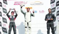Qatar’s Abdulla Al Khelaifi (centre), Saadon Al Kuwari and Ibrahim Al Abdulghani pose on the podium after a Qatar Touring Car Championship race at Losail International Circuit yesterday.   
