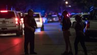 An officer assists local residents trying to get to their homes near the scene of a shooting where five Houston police officers were reported shot January 28, 2019 in Houston, Texas. Loren Elliott/Getty Images/AFP