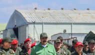This handout picture released by the Venezuelan presidency shows Venezuela's President Nicolas Maduro (C) and Defence Minister Vladimir Padrino (L) taking part in a ceremony during military exercises at the Libertador Air Base in Maracay, Aragua state, Ve