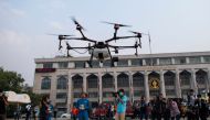 Bangkok Metropolitan Administration (BMA) officials watch a drone taking off fitted with a water tank during a demonstration to make artificial rain to tackle air pollution in Bangkok on January 31, 2019. AFP / Jewel SAMAD