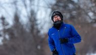 A runner passes through heavy frost in Nokomis Lake, south west Minneapolis, as temperatures in the area dipped below freezing overnight in Minnesota on January 29, 2019. AFP / Kerem Yucel