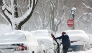 Woman clears a car in the snow during a winter storm in Buffalo, New York, U.S., January 31, 2019. (REUTERS/Lindsay DeDario)