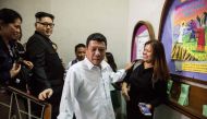 A Philippine President Rodrigo Duterte impersonator (C), who goes by the name Cresencio Extreme, and a North Korean leader Kim Jong Un impersonator (2nd L), who goes by the name Howard X, attend a church service in the Central district of Hong Kong on Feb