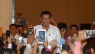 FILE PHOTO: Philippine President Rodrigo Duterte greets people before a meeting with the Filipino Community at a hotel in Phnom Penh, December 13, 2016. Reuters/Samrang Pring