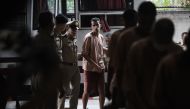 Hakeem al-Araibi (C), a Bahraini refugee and Australian resident, is escorted to a courtroom in Bangkok on February 4, 2019. AFP / Lillian SUWANRUMPHA