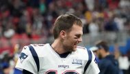 Quarterback for the New England Patriots Tom Brady (12) speaks with running back for the New England Patriots James White (out of frame) before the Super Bowl LIII between the New England Patriots and the Los Angeles Rams at Mercedes-Benz Stadium in Atlan