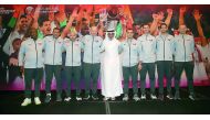 The QFA President poses for a photograph with the support staff of Qatar national team.