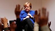 Students raise their hands to ask a question to German Chancellor Angela Merkel during her talk with students at Keio University in Tokyo, Japan, February 5, 2019. REUTERS/Issei Kato