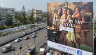 Indian commuters pass a poster advertising Facebook Live 'What You Love' campaign in Bangalore on March 22, 2018. AFP / Manjunath Kiran