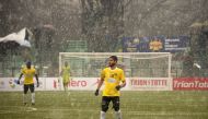 In this photo taken on February 6, 2019, Real Kashmir's Danish Farooq looks on amid snowfall during their I-League club football match against Gokulam Kerala FC at the Tourist Reception Centre football ground in Srinagar. / AFP / Tauseef MUSTAFA 