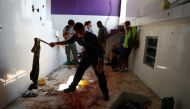 A police forensic expert checks a cloth on a blood-stained floor at a house where police officers confronted suspects during an operation against drug gangs at Fallet slum in Rio de Janeiro, Brazil February 8, 2019. Reuters/Pilar Olivares