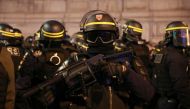 A riot police officer stands with a tear gas launcher during a demonstration in Paris on February 9, 2019 as the 