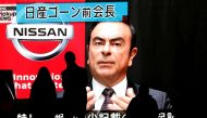 FILE PHOTO: Passersby are silhouetted as a huge street monitor broadcasts news reporting ousted Nissan Motor chairman Carlos Ghosn's indictment and re-arrest in Tokyo, Japan December 10, 2018. REUTERS/Issei Kato/File Photo