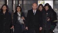 US Deputy Trade Representative Jeffrey Gerrish (C) and members of his negotiation team leave a hotel ahead of a meeting with Chinese officials in Beijing on February 11, 2019. / AFP / NICOLAS ASFOURI 