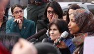 US Representative Alexandria Ocasio-Cortez (D-NY) and Representative Rashida Tlaib (D-MI) wipe away tears as Representative Ilhan Omar (D-MN) talks about her own experience as a refugee during a news conference to call on Congress to cut funding for ICE (