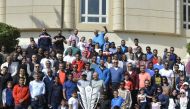Senior executives of QIB, and the bank’s employees and their families posing for a group photo. 