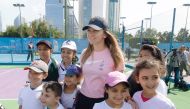 Simona Halep poses for a picture along with young fans as she attends the National Sport Day related event at Khalifa International Tennis Complex, yesterday.  