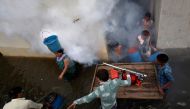 File photo: A municipal worker fumigates a flooded alley to prevent the spread of dengue fever and other mosquito-borne diseases at a residential colony in Ahmedabad, India, July 29, 2017. Reuters/Amit Dave