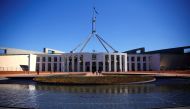 FILE PHOTO - Tourists walk around the forecourt of Australia's Parliament House in Canberra, Australia, October 16, 2017. REUTERS/David Gray/File Photo	