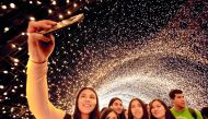 People enjoy a light show during the festivities for the 477th anniversary of the foundation of Guadalajara, Mexico, on February 14, 2019. The city begins the anniversary celebrations on February 14 with the largest robotic light festival in Latin America