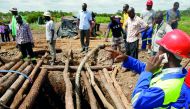 People gather over a shaft as retrieval efforts proceed for trapped illegal gold miners in Kadoma, Zimbabwe, February 15, 2019. Reuters/Philimon Bulawayo