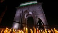 A soldier walks during a candle light vigil to pay tribute to Central Reserve Police Force (CRPF) personnel who were killed after a suicide bomber rammed a car into the bus carrying them in south Kashmir on Thursday, in front of India Gate war memorial in