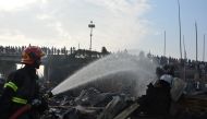 A firefighter works to extinguish fire at a slum where at least eight people were killed in Chittagong, Bangladesh February 17, 2019. REUTERS
