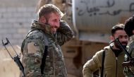 Fighters of the US-backed Kurdish-Arab coalition of the Syrian Democratic Forces (SDF) take a rest during an operation to expel Islamic State group (IS) jihadists from their last bastion, in Baghouz in the eastern Syrian province of Deir Ezzor on February