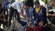 Venezuelan opposition leader and self-declared acting president Juan Guaido (L) greets volunteers of the movement 