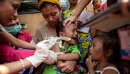 A child reacts during a Philippine Read Cross Measles Outbreak Vaccination Response in Baseco compound, a slum area in Manila on February 16, 2019.   AFP / Noel CELIS
