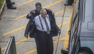 A lawyer  helps Bill Cosby put his suit coat on after Cosby arrived at the Montgomery County Courthouse on August 22, 2017 in Norristown, Pennsylvania. AFP/Michael Bryant