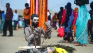 An Indian sadhu sits on the banks of Sangam -- the confluence of the Ganges, Yamuna and mythical Saraswati rivers -- on the auspicious bathing day of 'Maghi Purnima' during the Kumbh Mela festival in Allahabad on February 19, 2019.  AFP / Sanjay Kanojia 