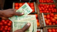 A man counts bond notes at a vegetable market in Harare, Zimbabwe, January 23, 2019. Reuters/Philimon Bulawayo