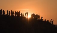 In this file photo taken on November 26, 2017, Rohingya Muslim refugees walk down a hillside in the Kutupalong refugee camp in Bangladesh. AFP/Ed Jones