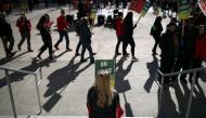 Oakland Unified School District students and teachers carry signs as they picket outside of Oakland Technical High School on February 21, 2019 in Oakland, California. Nearly 3,000 teachers in Oakland have gone on strike and are demanding a 12 percent retr