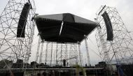 Workers set up a platform for the upcoming concert 