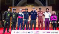 Qatari drivers Nasser Saleh Al Attiyah, Adel Abdulla and Ahmed Al Kuwari pose for a photograph with the defending FIA World Cup champion Jakub Przygonski, Camelia Liparoti, Vladimir Vasilyev and Reinaldo Varela prior to the ceremonial start of the Manateq