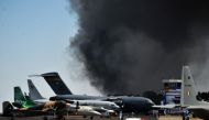 Smoke billows past a row of parked planes after a fire broke out in a parking lot during the Aero India show at the Yelahanka Air Force Station in Bengaluru, India, February 23, 2019. REUTERS