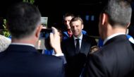 French President Emmanuel Macron (C) poses for a photo with breeders as he visits the 56th International Agriculture Fair (Salon international de l'Agriculture) at the Porte de Versailles exhibition center in Paris, on February 23, 2019. AFP / POOL / JULI