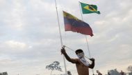 A protester uses a slingshot during clashes with Venezuelan soldiers along the border between Venezuela and Brazil in Pacaraima, Brazil February 23, 2019. REUTERS/Ricardo Moraes 