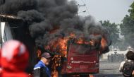 A bus burns down during a protest in the border city of Urena, Tachira, after President Nicolas Maduro's government ordered a temporary close-down of the border with Colombia on February 23, 2019.  AFP / JUAN BARRETO
