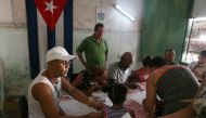 Election officials check the documents of a voter at a polling station during a constitutional referendum in Havana, Cuba, February 24, 2019. Reuters/Fernando Medina
