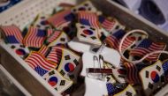 Pin badges are displayed as conservative anti-North Korea, pro-US activists march through central Seoul on February 23, 2019. / AFP / Ed JONES 