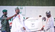 Nigeria's Independent National Electoral Commission (INEC) chairman Mahmood Yakubu displays vote result sheets on February 25, 2019 in Abuja during the presidential elections announcement. AFP / Kola SULAIMON