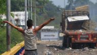 A protester holds a rock in his hand at the Francisco de Paula Santander Bridge in Tachira, Venezuela on February 24, 2019.  Daniel Salgar Antolinez - Anadolu 